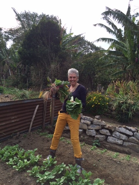 Photo of Debra L. Gish harvesting vegetables in the garden.